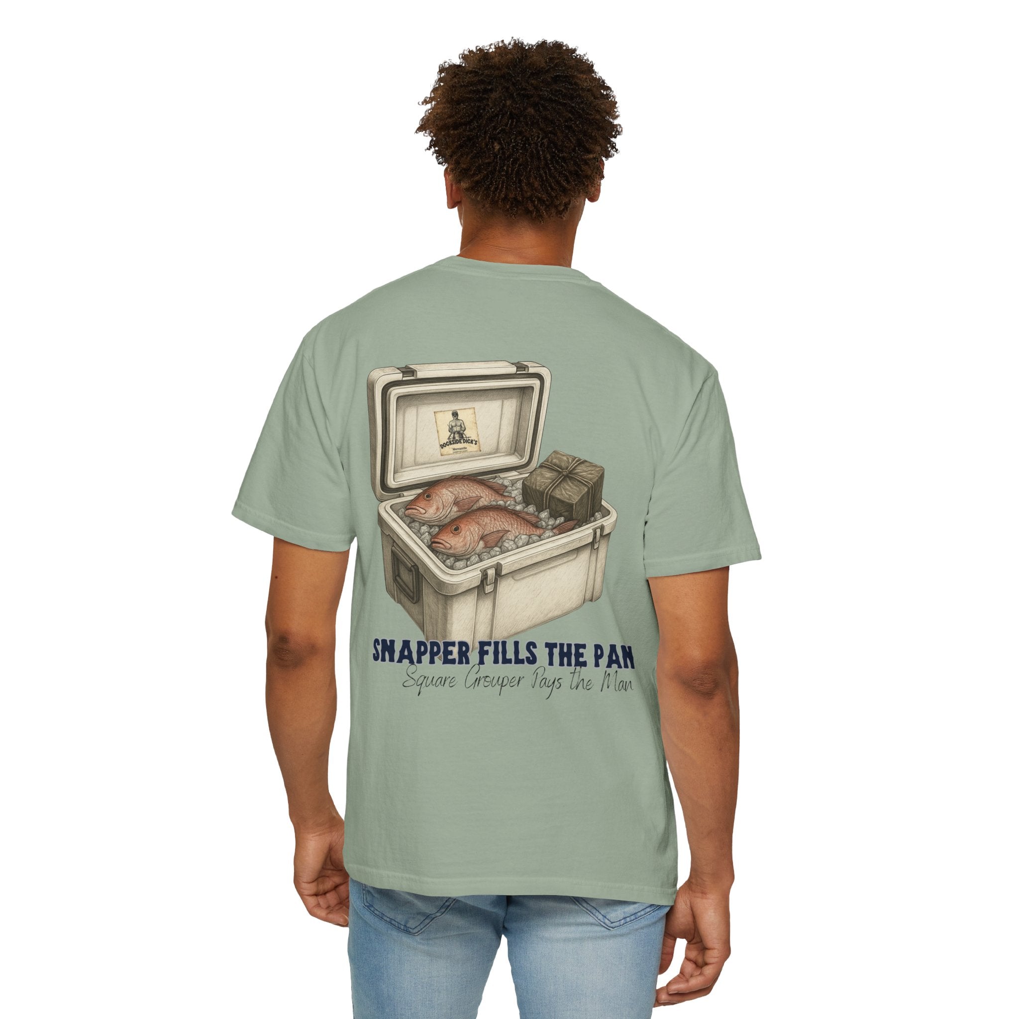 Man modeling sage green Lucky Day Tee - Square Grouper Shirt with illustrated fishing cooler on back, perfect for laid-back outdoor style.