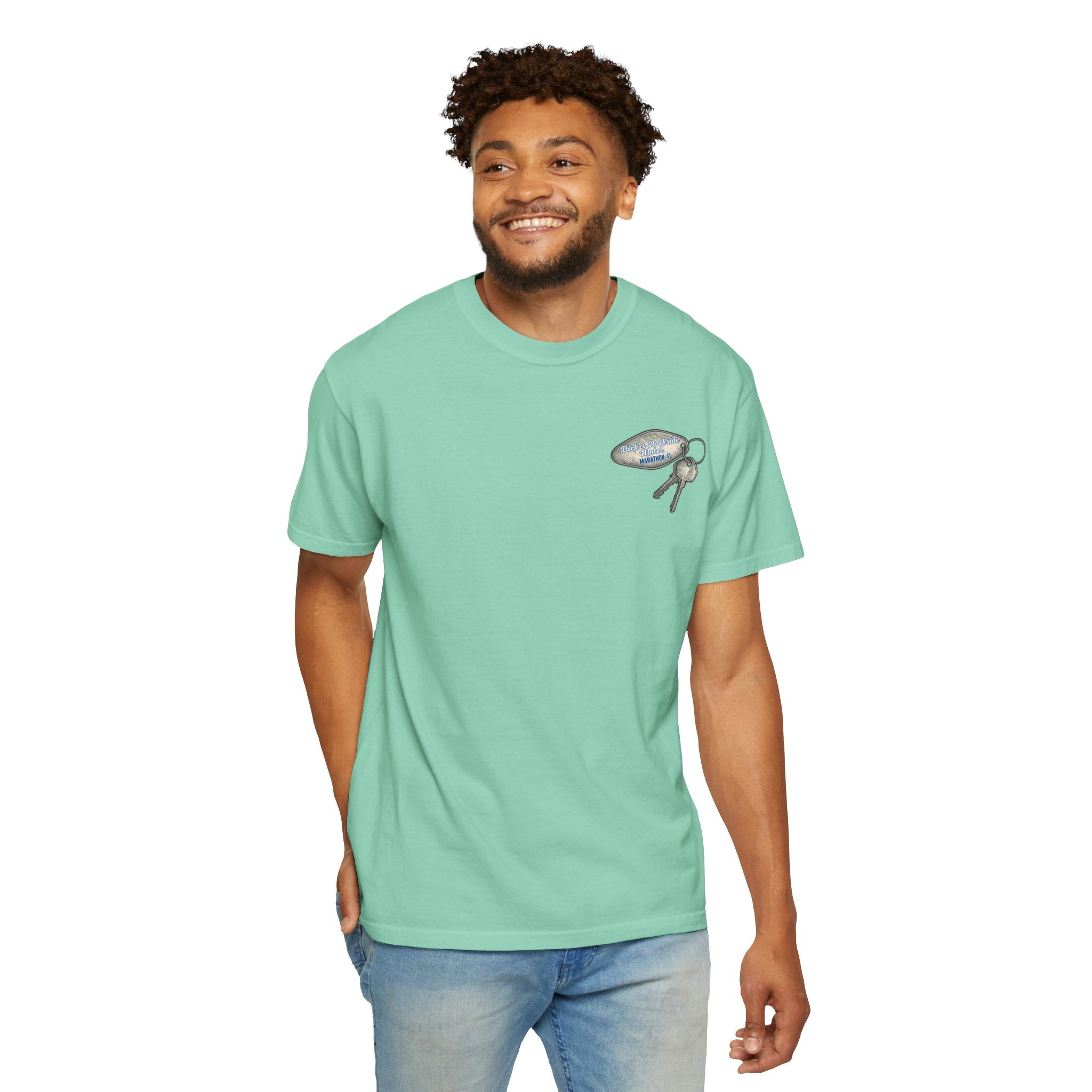 Man wearing a light green t-shirt with a graphic design on a white background