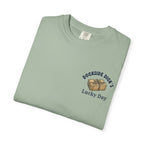 Folded sage green Lucky Day Tee - Square Grouper Shirt with Dockside Dick’s chest print, ideal for beach vibes and outdoor wear.